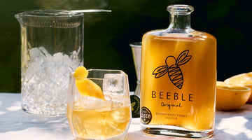 Beeble Honey Whisky Old Fashioned cocktail in a rocks glass with orange peel